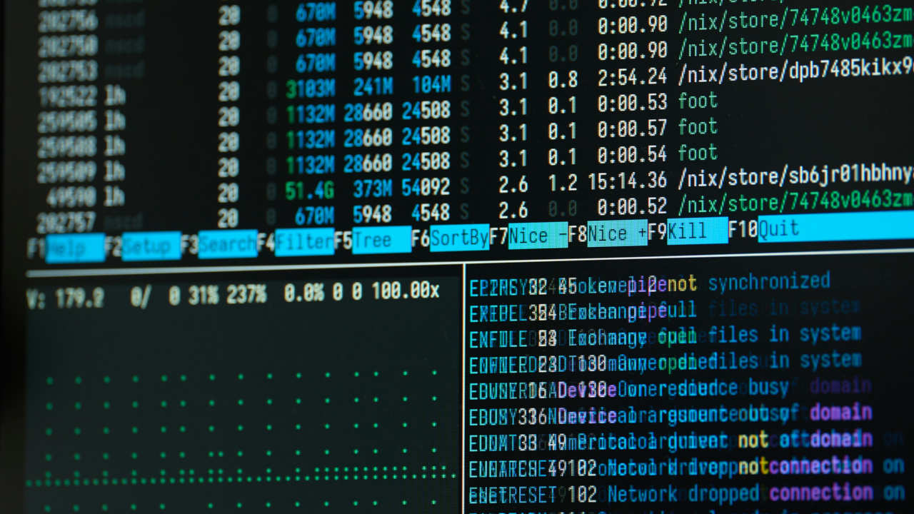 A photograph of a monitor showing a multipane terminal session.