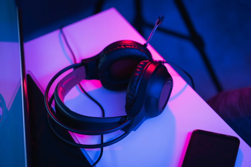 Pair of headphones resting on table. 