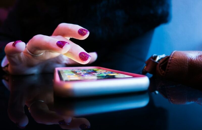 Woman reaching for her phone.