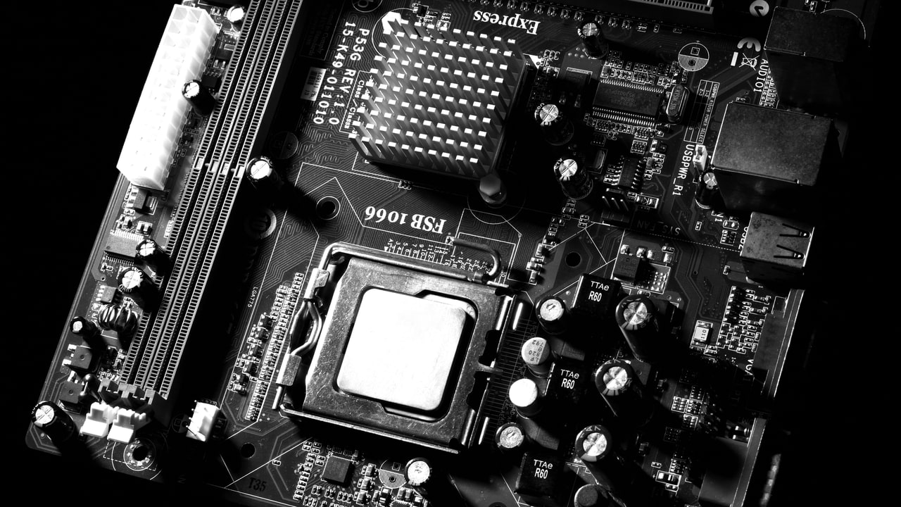 motherboard in black with circuits and sockets showing