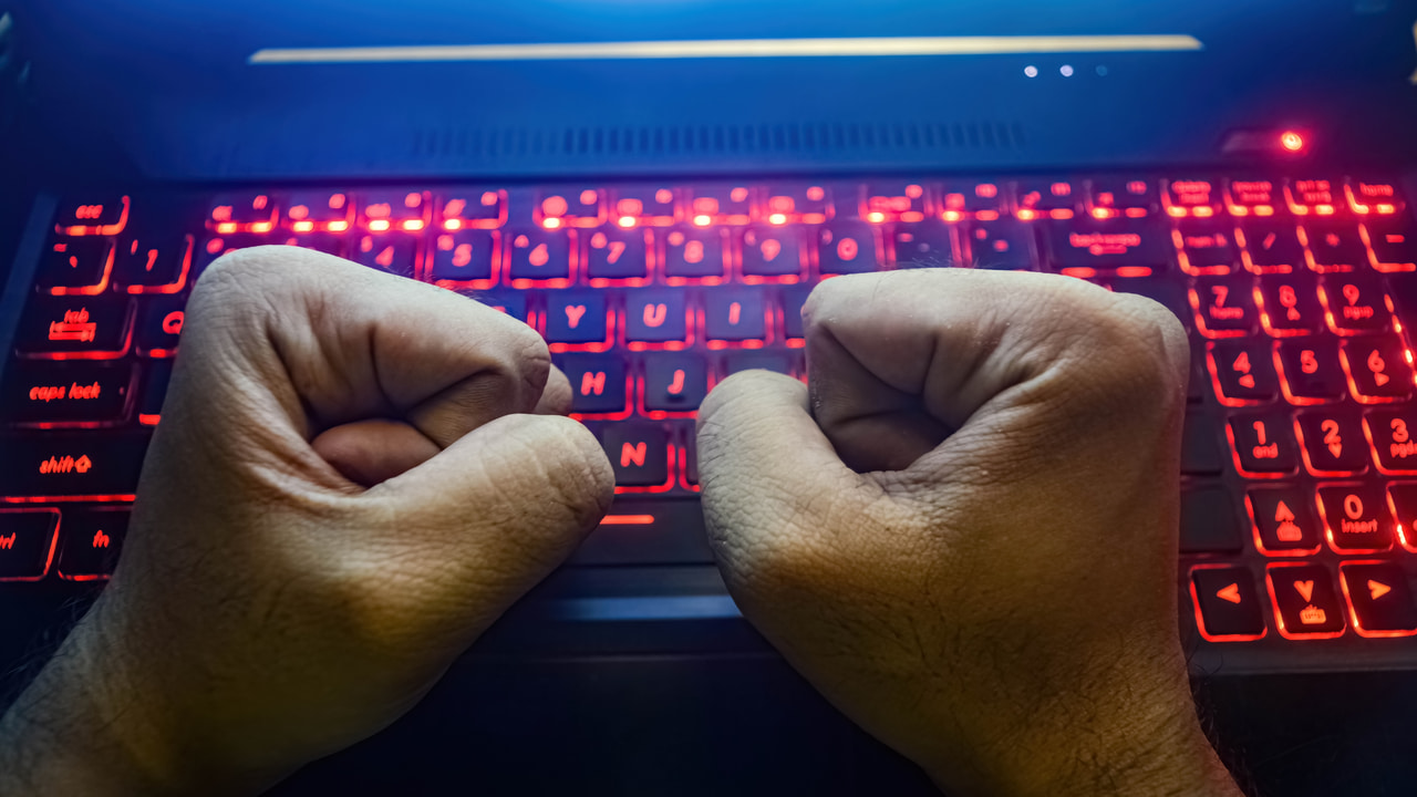 clenched fists on gaming keyboard