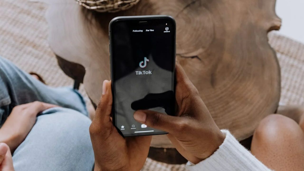 Person using TikTok on phone.